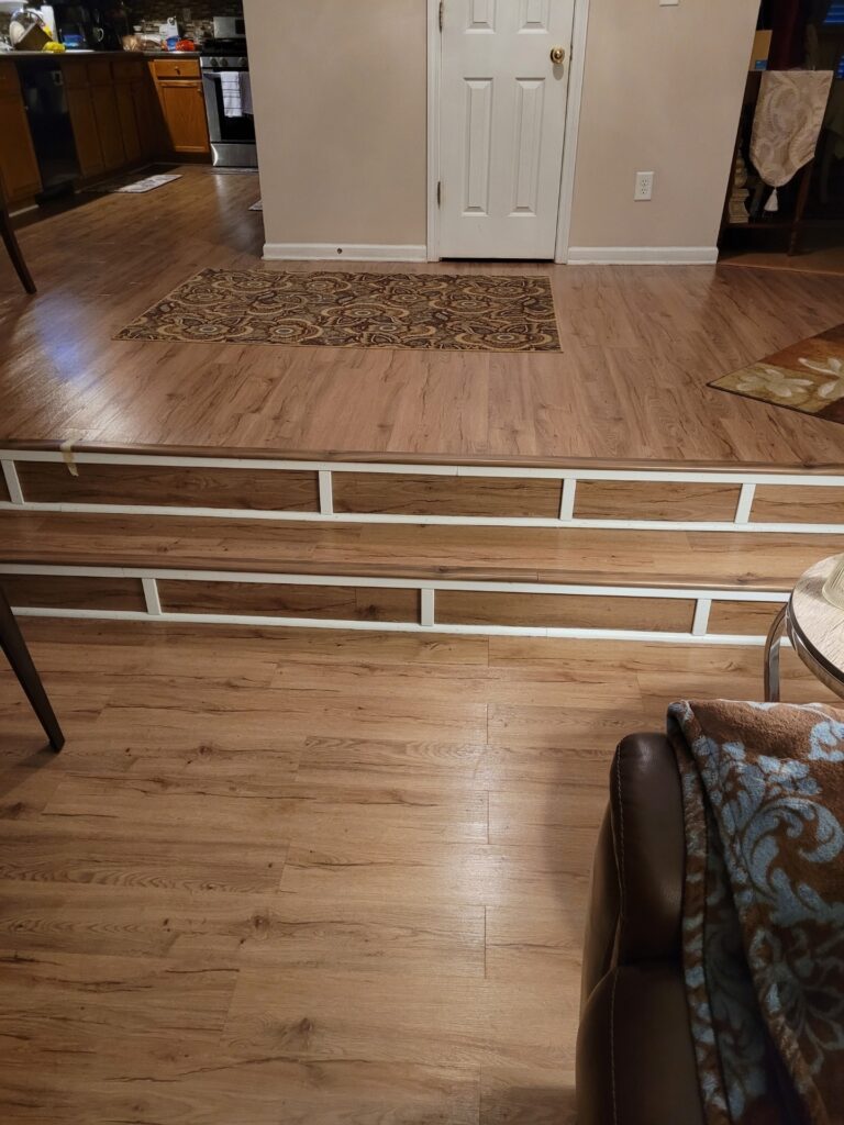 Living room with wooden floors and steps.