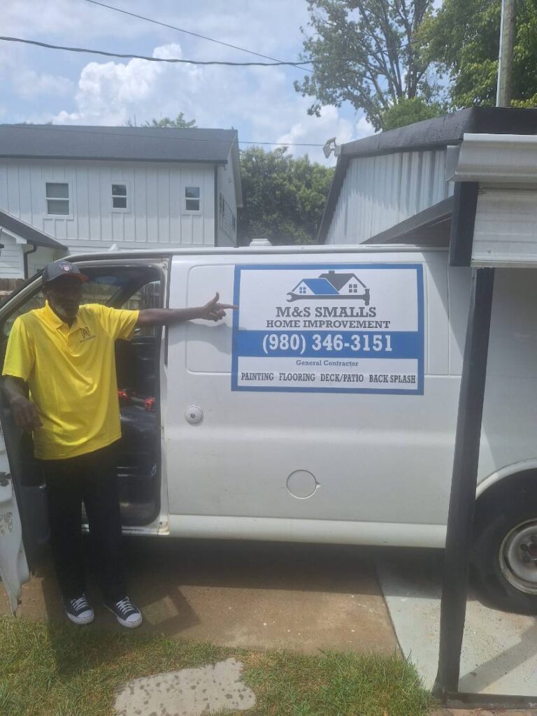 Man in yellow shirt pointing at truck sign for appliance repair services.