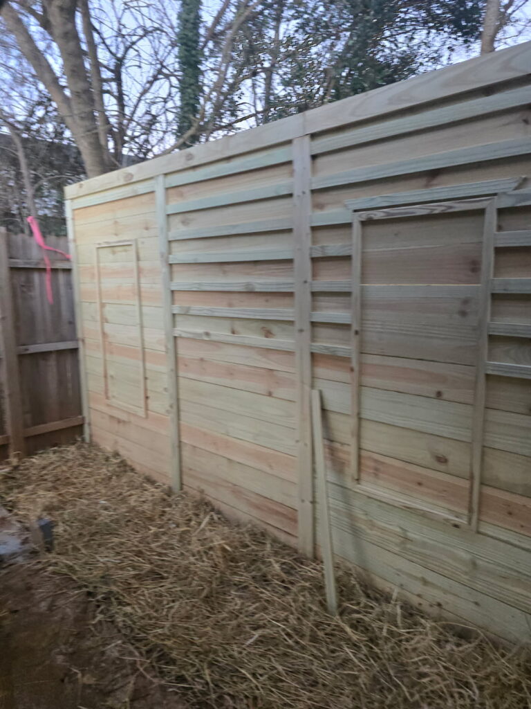 A white van with a home remodeling business advertisement on its side.